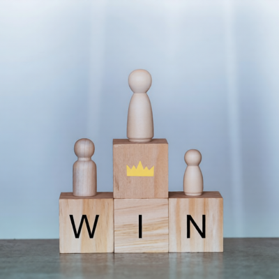 Champion and win concept. Wood block with and word win, wooden doll, Business and success concept.