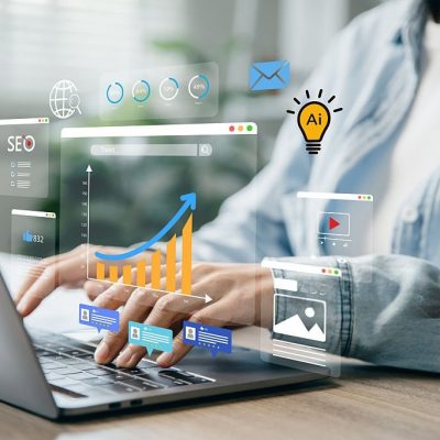 Woman using laptop to monitor online advertising metrics through a digital dashboard.